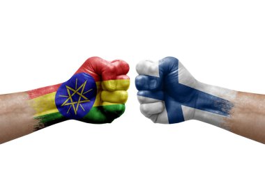 Two hands punch to each others on white background. Country flags painted fists, conflict crisis concept between ethiopia and finland