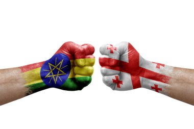 Two hands punch to each others on white background. Country flags painted fists, conflict crisis concept between ethiopia and georgia