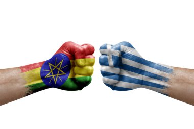 Two hands punch to each others on white background. Country flags painted fists, conflict crisis concept between ethiopia and greece