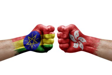 Two hands punch to each others on white background. Country flags painted fists, conflict crisis concept between ethiopia and hong kong