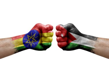Two hands punch to each others on white background. Country flags painted fists, conflict crisis concept between ethiopia and jordan