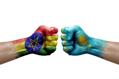 Two hands punch to each others on white background. Country flags painted fists, conflict crisis concept between ethiopia and kazakhstan