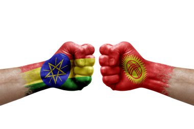 Two hands punch to each others on white background. Country flags painted fists, conflict crisis concept between ethiopia and kyrgyzstan