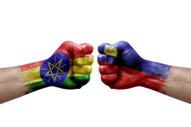 Two hands punch to each others on white background. Country flags painted fists, conflict crisis concept between ethiopia and liechtenstein