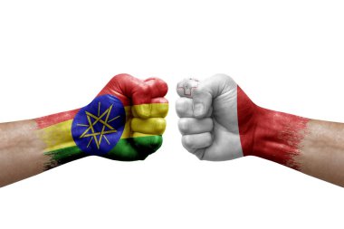 Two hands punch to each others on white background. Country flags painted fists, conflict crisis concept between ethiopia and malta
