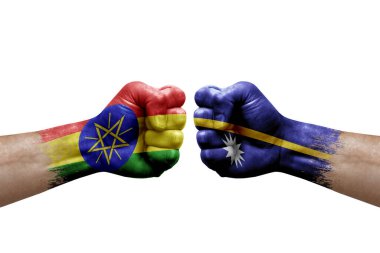 Two hands punch to each others on white background. Country flags painted fists, conflict crisis concept between ethiopia and nauru