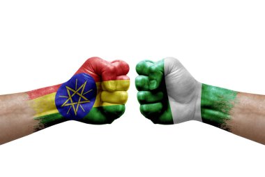 Two hands punch to each others on white background. Country flags painted fists, conflict crisis concept between ethiopia and nigeria