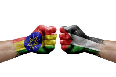 Two hands punch to each others on white background. Country flags painted fists, conflict crisis concept between ethiopia and palestine