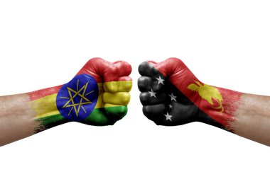 Two hands punch to each others on white background. Country flags painted fists, conflict crisis concept between ethiopia and papua new guinea