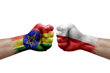 Two hands punch to each others on white background. Country flags painted fists, conflict crisis concept between ethiopia and poland
