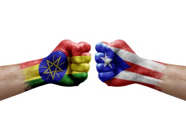 Two hands punch to each others on white background. Country flags painted fists, conflict crisis concept between ethiopia and puerto rico