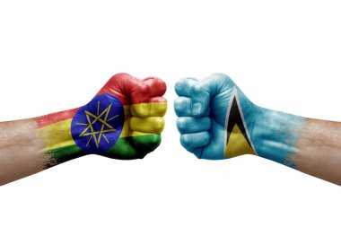 Two hands punch to each others on white background. Country flags painted fists, conflict crisis concept between ethiopia and saint lucia