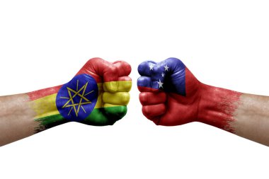 Two hands punch to each others on white background. Country flags painted fists, conflict crisis concept between ethiopia and samoa
