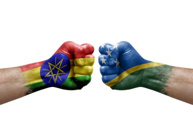 Two hands punch to each others on white background. Country flags painted fists, conflict crisis concept between ethiopia and solomon islands