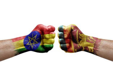 Two hands punch to each others on white background. Country flags painted fists, conflict crisis concept between ethiopia and sri lanka