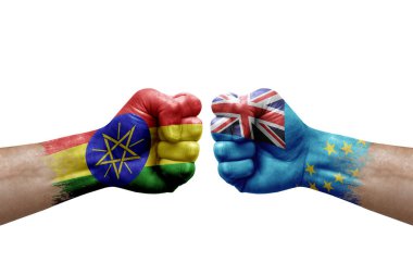 Two hands punch to each others on white background. Country flags painted fists, conflict crisis concept between ethiopia and tuvalu
