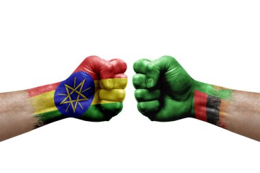 Two hands punch to each others on white background. Country flags painted fists, conflict crisis concept between ethiopia and zambia