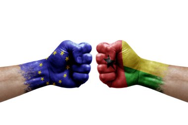 Two hands punch to each others on white background. Country flags painted fists, conflict crisis concept between european union and guinea-bissau