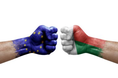 Two hands punch to each others on white background. Country flags painted fists, conflict crisis concept between european union and madagascar