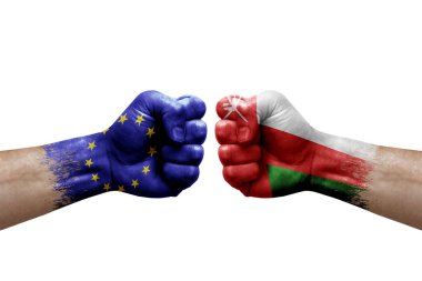 Two hands punch to each others on white background. Country flags painted fists, conflict crisis concept between european union and oman