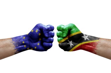 Two hands punch to each others on white background. Country flags painted fists, conflict crisis concept between european union and saint kitts and nevis
