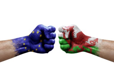 Two hands punch to each others on white background. Country flags painted fists, conflict crisis concept between european union and wales