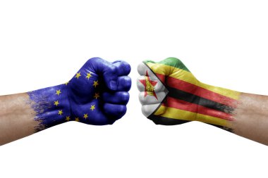 Two hands punch to each others on white background. Country flags painted fists, conflict crisis concept between european union and zimbabwe
