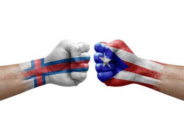 Two hands punch to each others on white background. Country flags painted fists, conflict crisis concept between faroe islands and puerto rico
