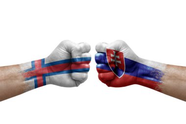 Two hands punch to each others on white background. Country flags painted fists, conflict crisis concept between faroe islands and slovakia