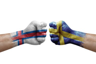 Two hands punch to each others on white background. Country flags painted fists, conflict crisis concept between faroe islands and sweden