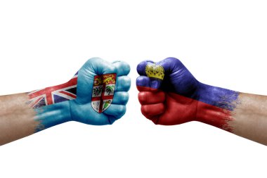 Two hands punch to each others on white background. Country flags painted fists, conflict crisis concept between fiji and liechtenstein