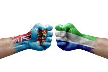 Two hands punch to each others on white background. Country flags painted fists, conflict crisis concept between fiji and sierra leone