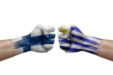 Two hands punch to each others on white background. Country flags painted fists, conflict crisis concept between finland and uruguay