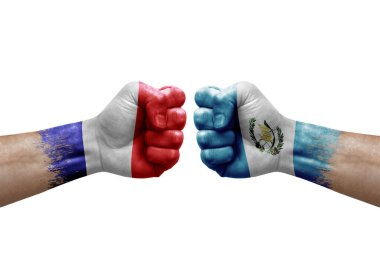 Two hands punch to each others on white background. Country flags painted fists, conflict crisis concept between france and guatemala