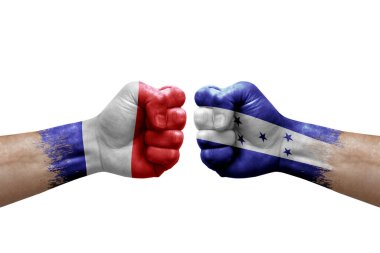 Two hands punch to each others on white background. Country flags painted fists, conflict crisis concept between france and honduras