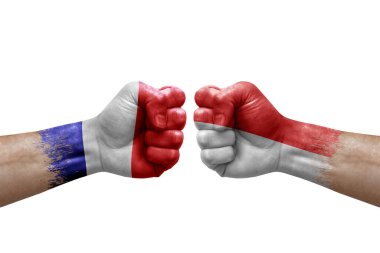 Two hands punch to each others on white background. Country flags painted fists, conflict crisis concept between france and indonesia