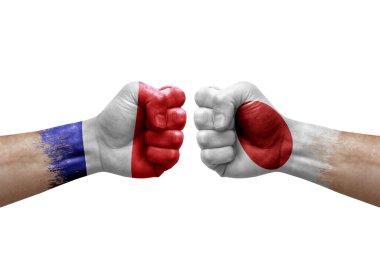 Two hands punch to each others on white background. Country flags painted fists, conflict crisis concept between france and japan