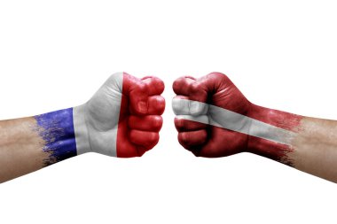 Two hands punch to each others on white background. Country flags painted fists, conflict crisis concept between france and latvia
