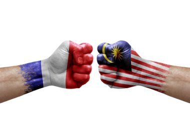 Two hands punch to each others on white background. Country flags painted fists, conflict crisis concept between france and malaysia