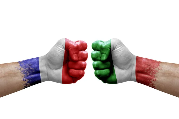 Two hands punch to each others on white background. Country flags painted fists, conflict crisis concept between france and italy