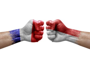 Two hands punch to each others on white background. Country flags painted fists, conflict crisis concept between france and monaco