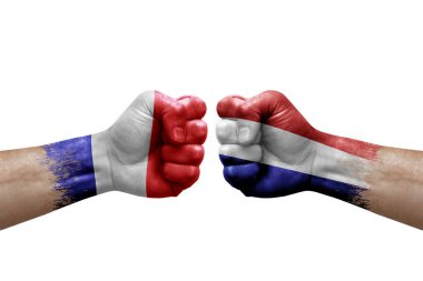 Two hands punch to each others on white background. Country flags painted fists, conflict crisis concept between france and netherlands