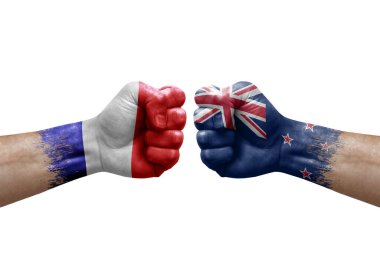 Two hands punch to each others on white background. Country flags painted fists, conflict crisis concept between france and new zealand