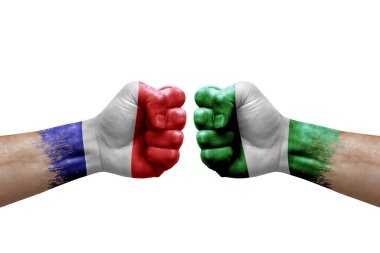 Two hands punch to each others on white background. Country flags painted fists, conflict crisis concept between france and nigeria
