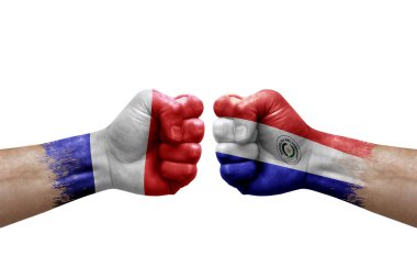 Two hands punch to each others on white background. Country flags painted fists, conflict crisis concept between france and paraguay