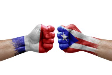 Two hands punch to each others on white background. Country flags painted fists, conflict crisis concept between france and puerto rico