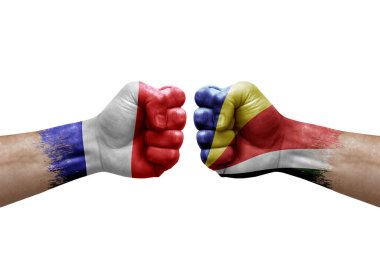 Two hands punch to each others on white background. Country flags painted fists, conflict crisis concept between france and seychelles