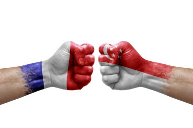 Two hands punch to each others on white background. Country flags painted fists, conflict crisis concept between france and singapore