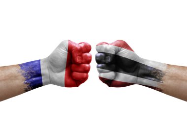 Two hands punch to each others on white background. Country flags painted fists, conflict crisis concept between france and thailand