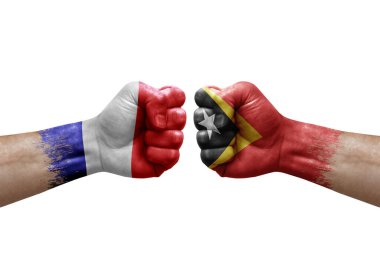 Two hands punch to each others on white background. Country flags painted fists, conflict crisis concept between france and timor leste